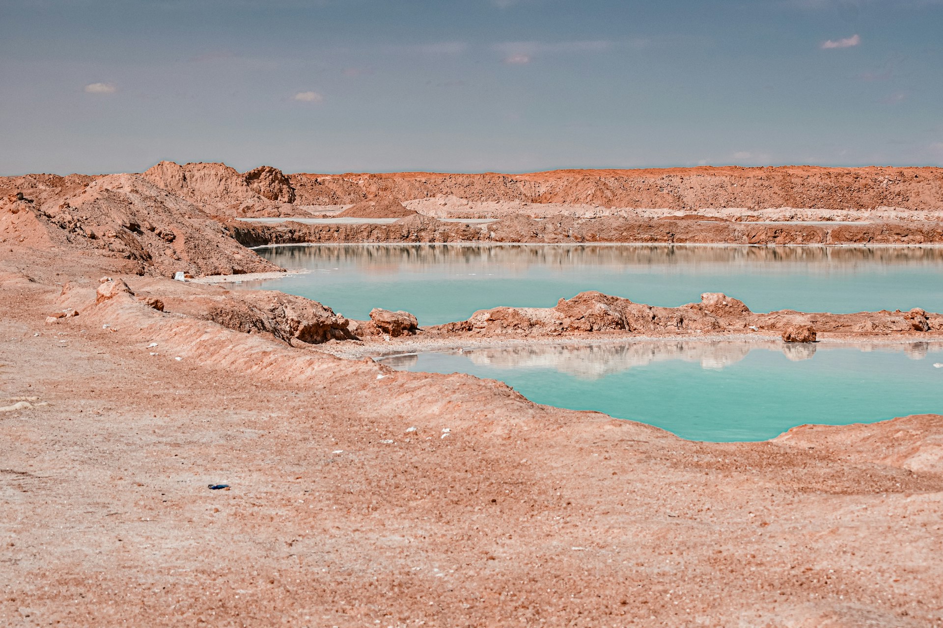 Turquoise water reflects across a desolate landscape.